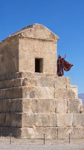 Hyper-realistic live-action footage, real location, natural colors. On top of the stepped stone Tomb of Cyrus, the smal…